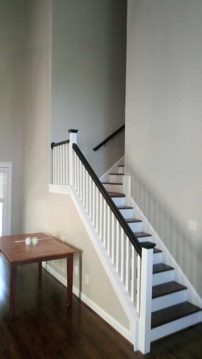 Entry staircase with fresh wall color and white-painted balusters