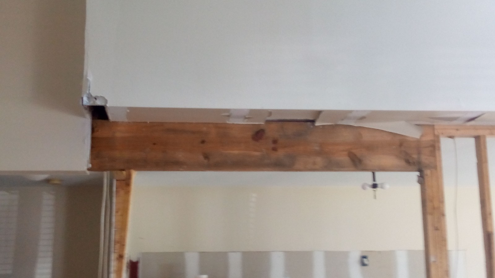 Ceiling and header with drywall removed, framing exposed