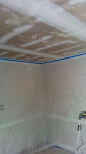 Room fully masked and floors protected before spraying