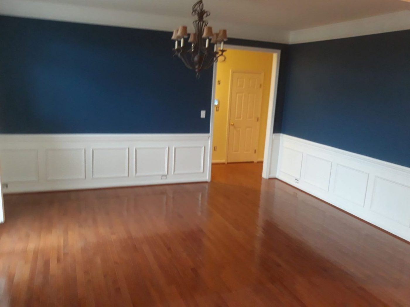 Dining room painted navy above white wainscot paneling