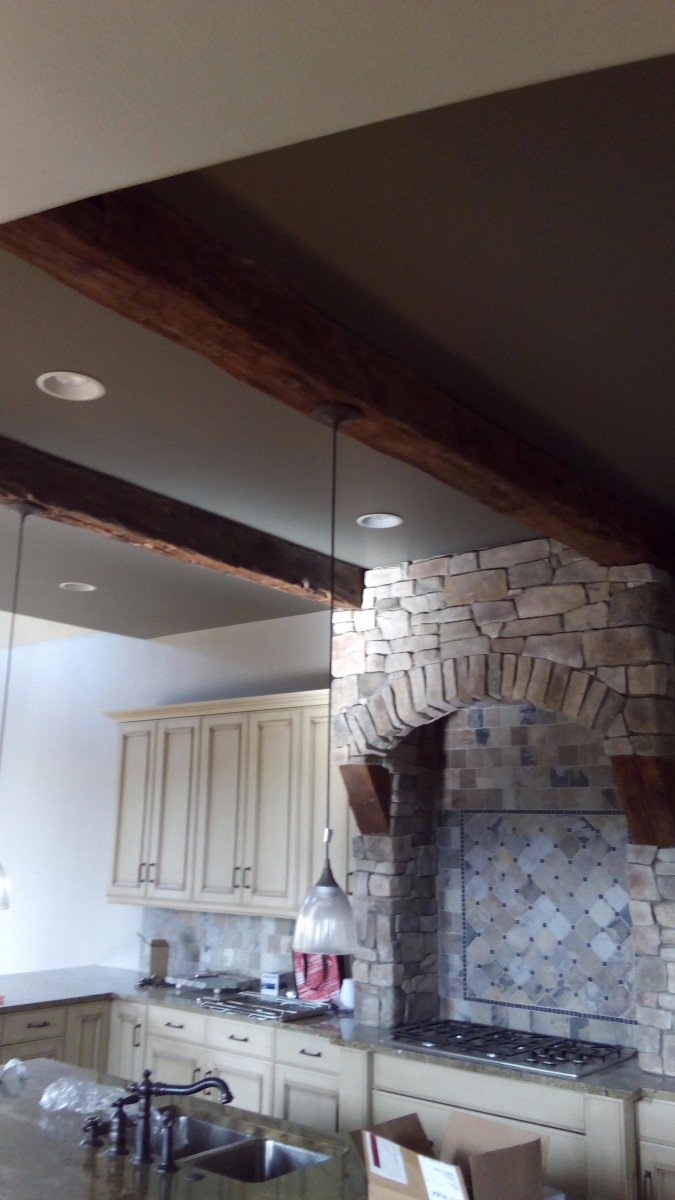 Vaulted kitchen ceiling painted around exposed timber beams
