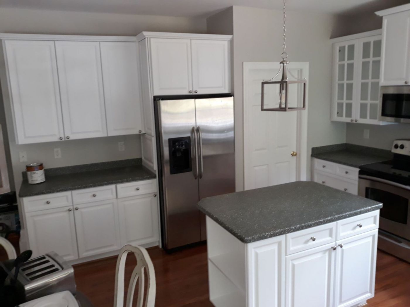 Kitchen cabinets sprayed white with a smooth, factory-like finish